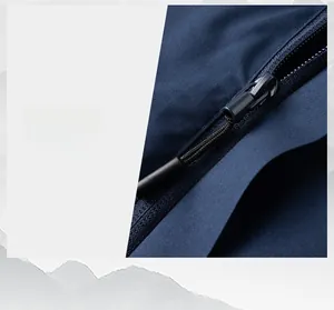 Detail shot of smooth zipper and precise stitching on dark blue outdoor jacket fabric
