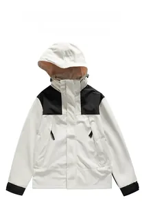 Detail view of water-resistant outdoor jacket with detachable hood and adjustable cuffs