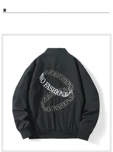 Detail of black bomber jacket featuring white circular embroidery on the back with ribbed cuffs