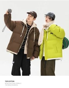 Close-up of retro functional padded jacket in dark brown and neon green for couples