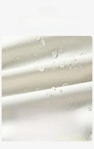 Macro shot of waterproof tech fabric with water droplets showing lotus effect and stain resistance