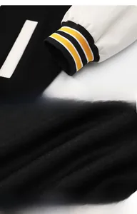 Detail of ribbed windproof cuffs and thick padded lining on patchwork baseball jacket