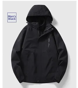 Detail of black waterproof outdoor jacket with hood, zipper, and mountain chest logo
