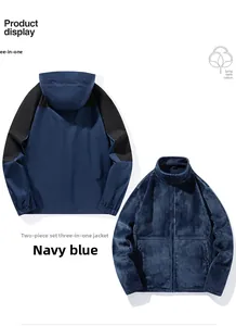 Close-up of a 3-in-1 navy blue outdoor jacket with detachable fleece lining and black panels