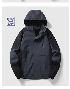 Detail of dark grey men's outdoor waterproof jacket with adjustable hood and zip pockets