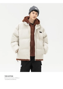 Detail of beige quilted puffer jacket with hooded design and vintage workwear aesthetic
