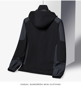 Detail view of the black and grey outdoor jacket featuring elastic cuffs and hooded design