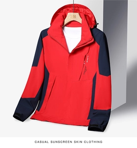 Detail view of red and navy windproof jacket with hooded design and zipped sport chest pocket