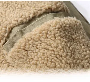 Detail of warm brown sherpa fleece lining and internal zipper pocket on jacket