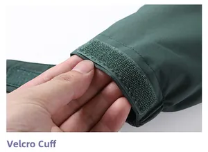 Detail of adjustable Velcro cuffs on a dark green waterproof outdoor hiking jacket