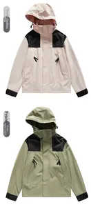 Detail of outdoor hooded jackets in pink and green with waterproof functional fabric