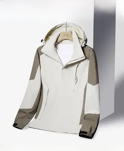 Close-up of the hooded outdoor waterproof jacket in beige and khaki patchwork design