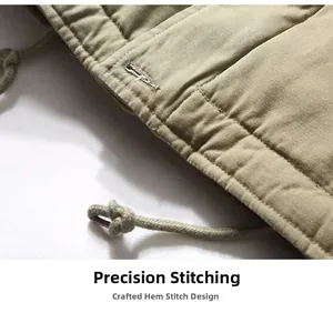 Detailed close-up of khaki jacket hem featuring precision stitching and woven drawstring
