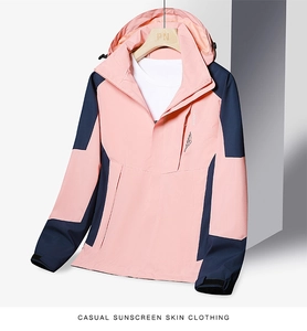 Detail of outdoor jacket showing chest zipper pocket and pink-navy color block design