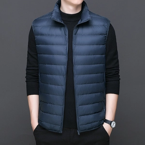 Men's lightweight navy blue down vest with stand collar and zipper closure over black sweater