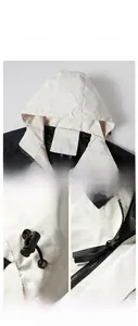 Detail of detachable hood and adjustable drawstring on a two-tone outdoor jacket