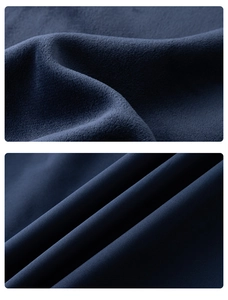 Detailed view of dark blue outdoor jacket showing warm fleece lining and smooth outer fabric