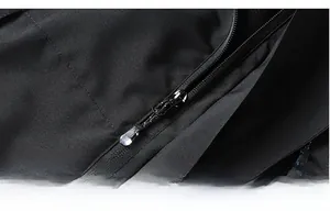 Detailed macro view of the durable metal zipper on a black outdoor waterproof jacket