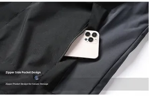 Detail of outdoor jacket showing zippered side pocket with phone for storage capacity