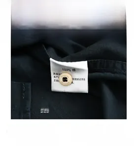 Macro shot of 100% cotton navy blue shirt fabric texture and branded buttons
