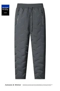 Détail du pantalon d'hiver gris foncé avec surpiqûres diagonales et poche zippée en métal