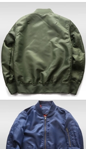 Detail view of military green and navy blue windproof bomber jackets with ribbed cuffs