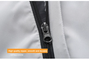 Close-up of high quality black matte metal zipper on grey windproof jacket fabric