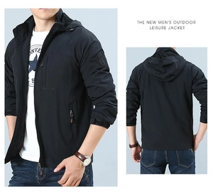 Detail of black outdoor jacket with zip chest pocket and mesh lining for breathability