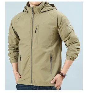 Detail of khaki outdoor hooded jacket featuring a decorative sleeve patch and zipper pocket