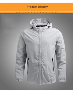 Detail of light grey windproof hooded jacket with zipper pockets and elastic cuffs