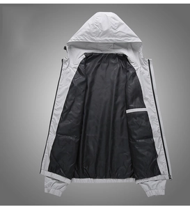 Detail of grey hooded jacket featuring black lining and functional internal pocket design