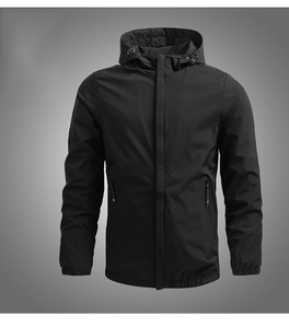 Detail of black hooded jacket featuring waterproof fabric, zipper pockets and elastic cuffs