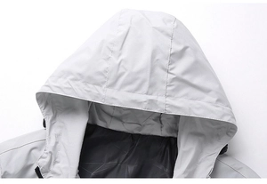 Detail of light grey hooded jacket featuring dark geometric patterned inner lining