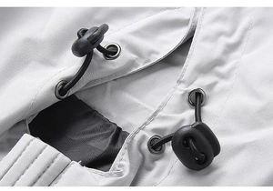 Macro detail of hooded jacket featuring adjustable black drawstring and toggle with metal eyelets