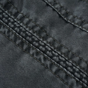 Detail of vintage washed cotton fabric with triple stitching on a casual men jacket