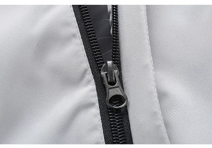 Detail of silver-grey functional fabric with premium matte black nylon zipper on men's jacket