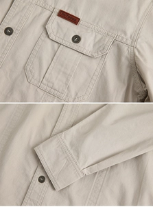 Detail of khaki cotton shirt featuring outdoor leather patch and vintage metal buttons