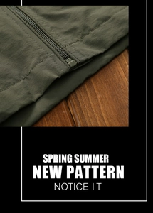 Detailed view of olive green jacket hem and high-quality zipper on vintage wood background