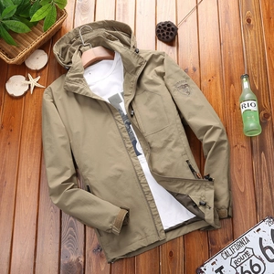 Men's khaki waterproof outdoor hooded windbreaker jacket with zip pockets on wood
