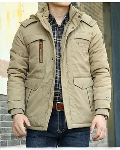 Detail of khaki men's winter parka showing ROUGH STOCK embroidery and windproof pockets