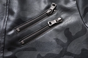 Macro detail of camouflage printed leather jacket with parallel silver metal zippers