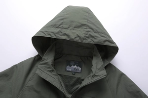 Detail of army green outdoor jacket collar with waterproof and windproof fabric