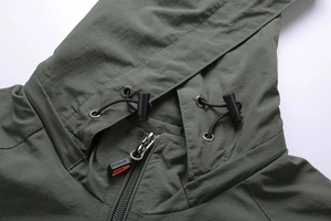 Detail view of military green jacket collar with SPORTS zipper pull and drawstring