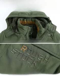 Close-up of olive green parka with warm fleece collar and rough stock embroidery