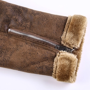 Detail of brown suede jacket sleeve with faux fur cuff and silver metal zipper