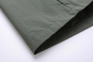 Detail of parallel double-line stitching on army green work jacket sleeve cuff