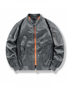 Detailed macro view of MA-1 bomber jacket with orange lining and tactical sleeve pocket