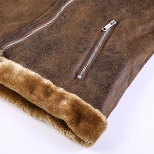 Detailed close-up of dark brown suede texture and thick faux shearling lining with metal zipper