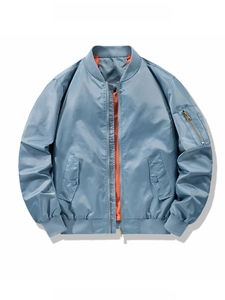 Detailed view of blue MA-1 flight jacket showing classic orange lining and brass zipper