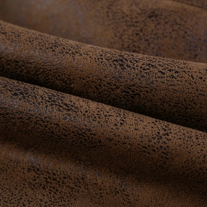 Macro shot of vintage brown distressed suede fabric with unique industrial weathered texture